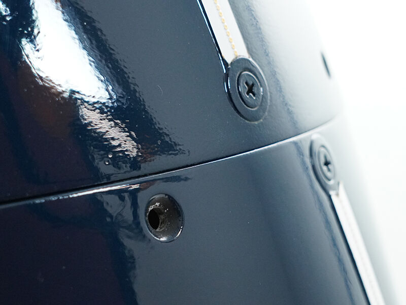 Multipart flight-qualified radome, detail of attachment points and lightning diverters. Surface is painted a glossy dark blue.