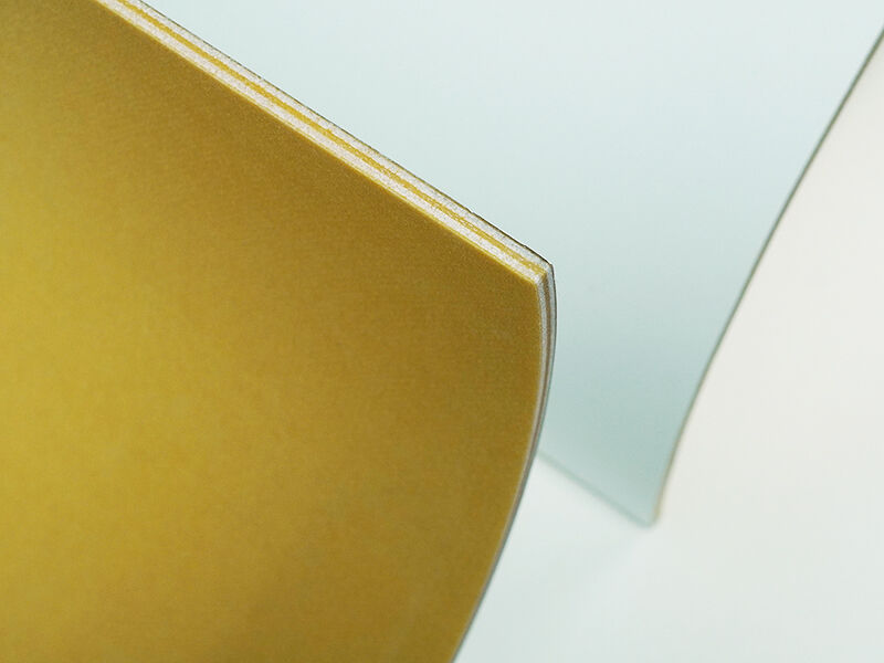 C-sandwich curved panel radome, edge Cropped image of two C-sandwich curved panel radomes showing the edge detail. Interior of the curve is yellowish in color. Outside is painted white. They are on a white background.