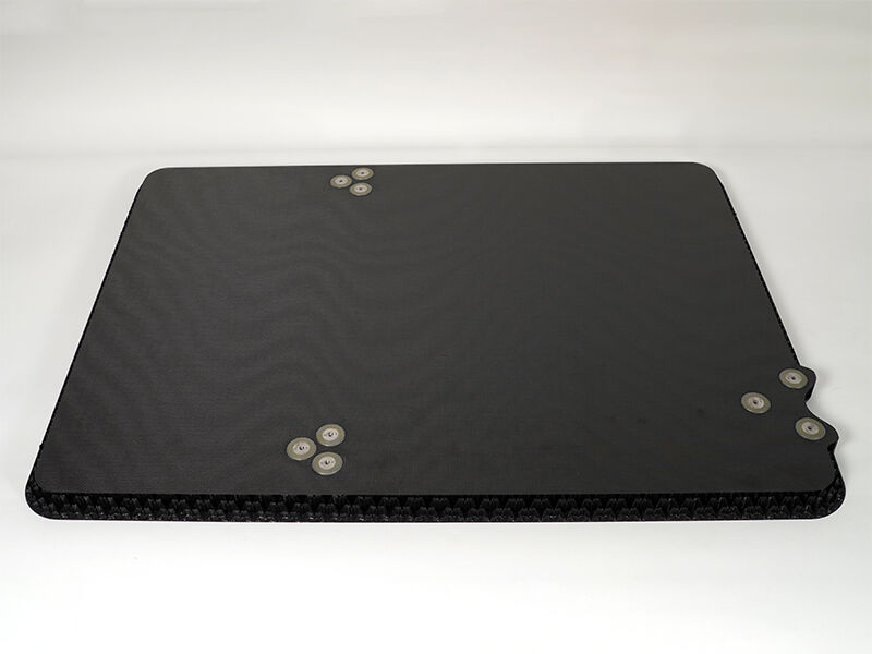 Reflector splashplate, carbon fiber plate and core A reflector splashplate is on a white background. There are three sets of three metallic inserts. The panel is constructed of carbon fiber face plates and a carbon core.