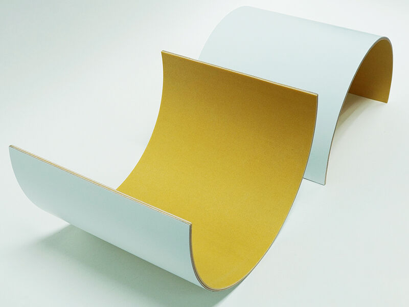 C-sandwich panel radomes, two pieces Image of two C-sandwich curved panel radomes, up with the interior facing up and one sitting interior down on the table. Interior of the curve is yellowish in color. Outside is painted white. They are on a white background.