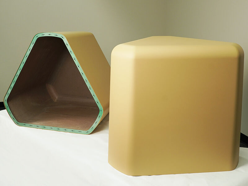 Low-cost ground radomes for military-end use. One radome sits on its base and one lays on its side showing the interio.