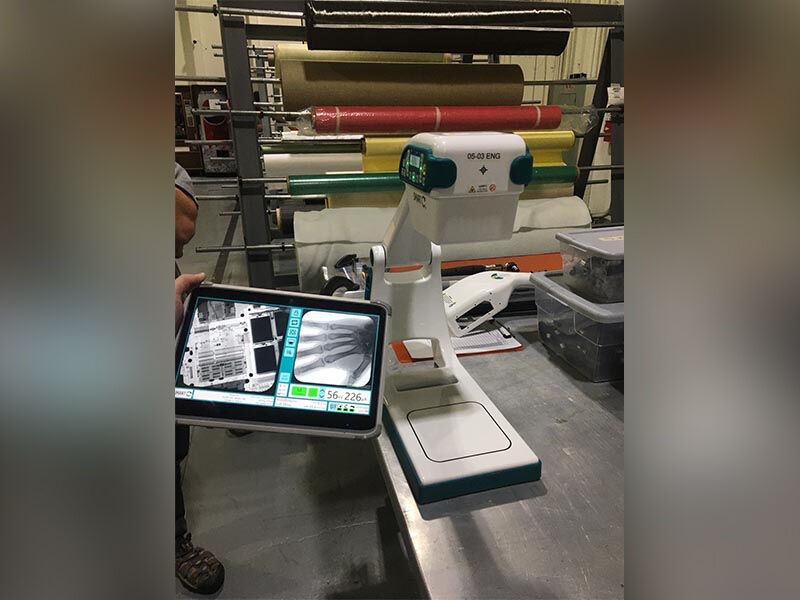 Portable X-ray device carbon fiber housing in manufacture Completed portable X-ray device in use