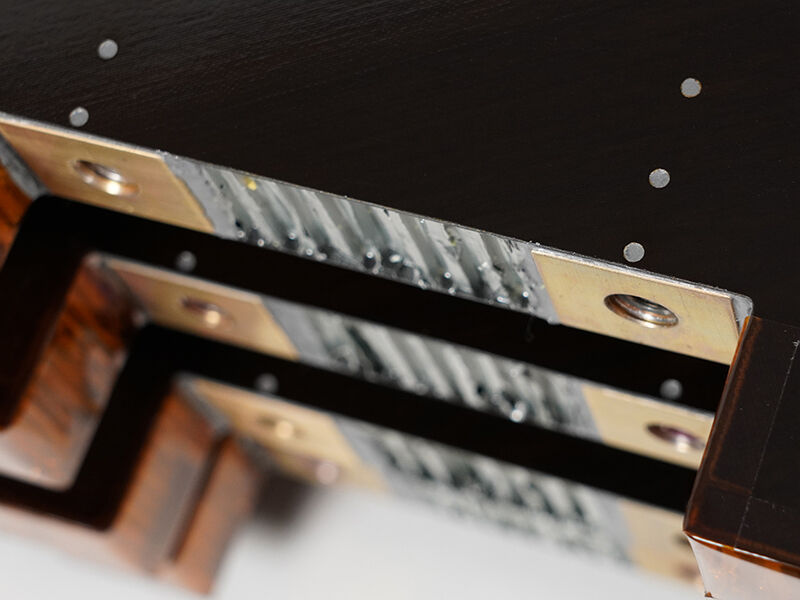 Stack of four DiskSat solar panels made of RWC's STRATOSubstrates™. Image shows exposed aluminum core, precision inserts and Kapton edging