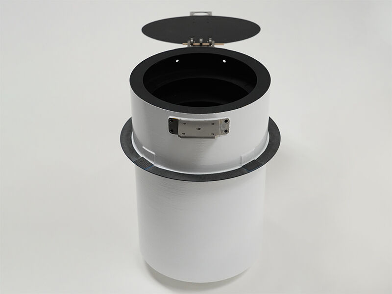 Sunshade exterior, open Image shows a white cylindrical sunshade structure with an open black lid on a white background. The black is carbon fiber, and the white is painted. There are metallic hinge structures for the lid.